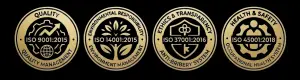 Four gold achievement badges showing ISO certifications for quality, environment, ethics, and health & safety on black background, 2015–2018 dates included
